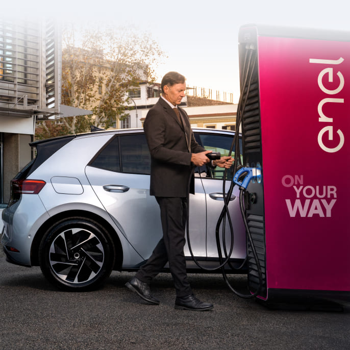 immaginie signore di fianco ad una macchina grigia che si approccia alla stazione waypump